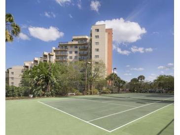 Tennis court with building in the background at 6165 Carrier Dr # 2103, Orlando, FL 32819