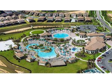 Aerial view of community pool, landscaping, and residential homes at 8979 Azalea Sands Ln, Davenport, FL 33896