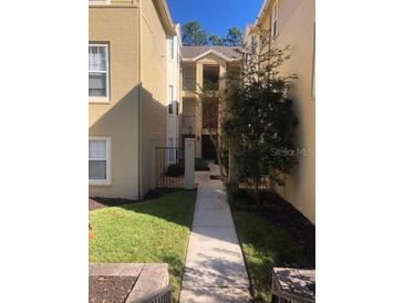 Exterior view of building showing walkway and landscaping at 413 Summit Ridge Pl # 305, Longwood, FL 32779