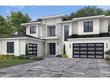 Two-story home with white siding, black garage doors, and a stone accent wall at 9144 Sheen Sound, Orlando, FL 32836