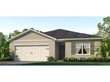 One-story house with a large white garage door and gray siding at 1760 Three Bars Rd, Kissimmee, FL 34744