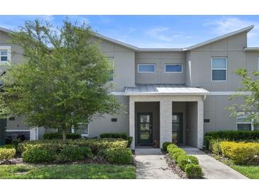 Modern 2-story townhome with attractive landscaping and a 2-car driveway at 820 Pebble Beach Dr, Davenport, FL 33896