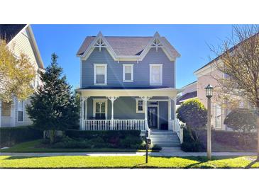 Charming two-story craftsman home with a wrap-around porch at 1133 Indigo Dr, Celebration, FL 34747
