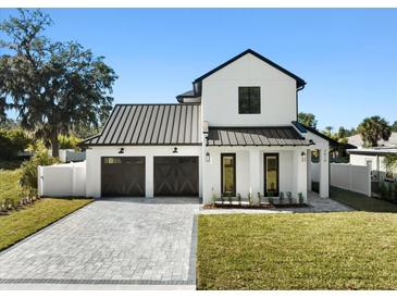 Modern farmhouse exterior with dark metal roof and two-car garage at 2619 Lafayette Ave, Winter Park, FL 32789