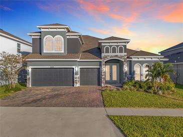 Two-story home with three-car garage and landscaped yard at 4408 Renly Ln, Clermont, FL 34711