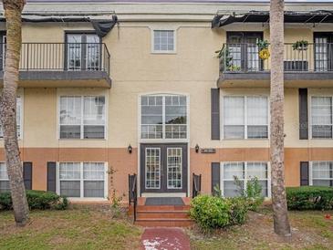 Inviting condo building entrance with landscaping at 4121 Dijon Dr # 4121H, Orlando, FL 32808