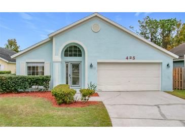 Charming light blue house with a well-maintained lawn at 425 Tree Shore Dr, Orlando, FL 32825