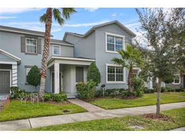 Two-story house with gray siding, landscaping, and a walkway at 7645 Fordson Ln, Windermere, FL 34786