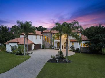 Stunning two-story home with tile roof and palm trees at 1140 Kelso Blvd, Windermere, FL 34786