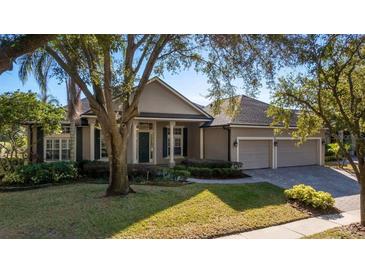 Beautiful two-story home with a three-car garage and manicured lawn at 1913 Westover Reserve Blvd, Windermere, FL 34786