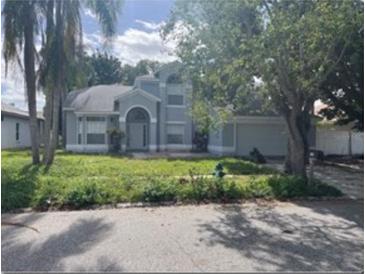 Two-story house with gray siding, attached garage, and manicured lawn at 2708 Smithfield Dr, Orlando, FL 32837