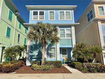 Beautiful two-story home with light blue exterior and palm trees at 8035 Surf St, Kissimmee, FL 34747