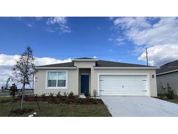 One-story home with white garage door and teal front door at 3771 Paragon Ln, Clermont, FL 34714