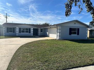 Newly renovated single-story home with a fresh coat of paint and landscaped lawn at 3522 E Kaley Ave, Orlando, FL 32806