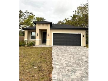 Newly constructed one-story home with a two-car garage and landscaped yard at 694 Schopke Lester Rd, Apopka, FL 32712