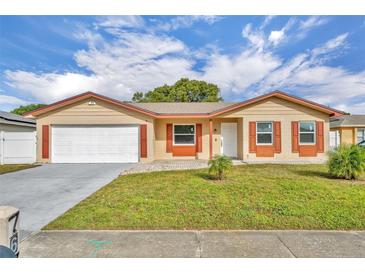 Updated single story home with a large front yard and attached garage at 7675 Nolton Way, Orlando, FL 32822