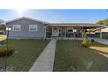 Gray single-story house with landscaped lawn and walkway at 2310 Fairgren Ave, Deltona, FL 32738