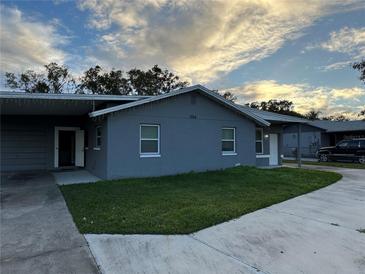 Charming single-story home with a welcoming front yard and driveway at 1704 Osceola Park Dr, Kissimmee, FL 34741