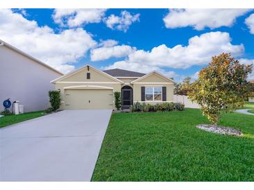 One-story house with green siding, gray roof and a two-car garage at 441 Tallow Wood Cir, Debary, FL 32713