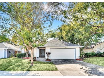 Charming single story home with a two car garage and manicured lawn at 6558 Grosvenor Ln, Orlando, FL 32835