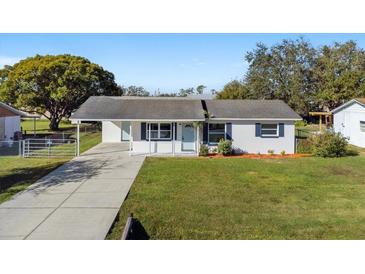 Newly renovated home with a spacious lawn and driveway at 2588 Sun Acres Blvd, Auburndale, FL 33823
