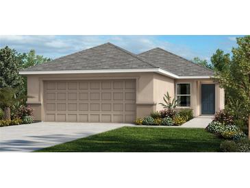 Attractive single-story home with a two-car garage and landscaped front yard at 8579 Caribbean Pine Way, Lakeland, FL 33809