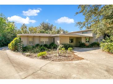 Ranch style home with a large front yard and mature trees at 7200 Grace Rd, Orlando, FL 32819