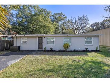 Newly renovated home with a gray brick exterior and a well-manicured lawn at 2418 34Th Nw St, Winter Haven, FL 33881