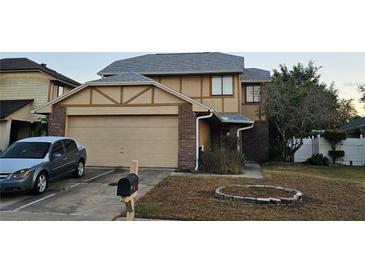 Charming two-story home with attached garage, landscaped yard, and white picket fence at 3563 S Saint Lucie Dr, Casselberry, FL 32707
