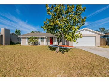 Charming single-story home with a red front door and large front yard at 4901 Leprechaun Way, Orlando, FL 32808