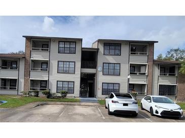 Two-story condo building with parking and landscaping at 4601 Cason Cove Dr # 214, Orlando, FL 32811