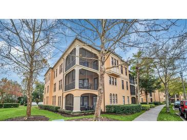 Tan three-story building with balconies and lush landscaping at 513 Mirasol Cir # 101, Celebration, FL 34747