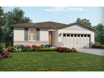 One-story home with a two-car garage, landscaping, and stone accents at 1104 Griffon Ave, Lake Alfred, FL 33850