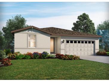 One-story home with a two-car garage and landscaped front yard at 1108 Griffon Ave, Lake Alfred, FL 33850