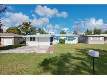 Ranch style home with a carport and well-manicured lawn at 1013 Carlson Dr, Orlando, FL 32804