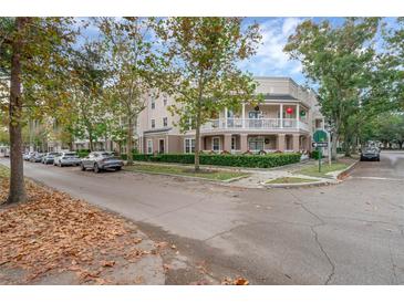 Charming townhome with a balcony, festive decorations, and street parking at 502 Water St, Celebration, FL 34747