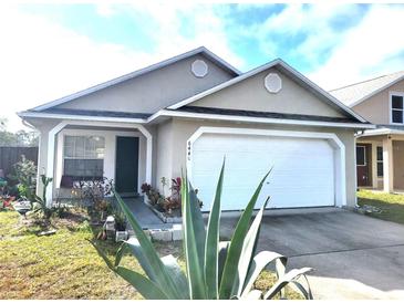 Charming single-story home with a welcoming front yard and attached garage at 6440 Livewood Oaks Dr, Orlando, FL 32818