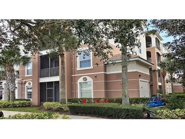 Attractive multi-story condo building with balconies and lush landscaping at 8252 Civita Dr # 201, Davenport, FL 33896
