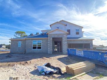 Two-story house under construction, featuring a block exterior and a large garage at 987 Hawksnest Pt, Oviedo, FL 32765