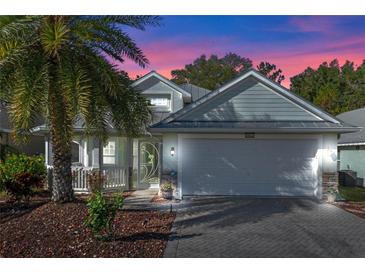 Attractive single-story home with a two-car garage and landscaped yard at 28023 Cypress Springs Loop, Okahumpka, FL 34762
