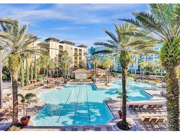 Resort-style pool with lounge chairs and palm trees at 12521 Floridays Resort Dr # 207F, Orlando, FL 32821
