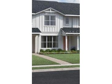 Charming two-story home with a welcoming front porch and landscaped yard at 1691 Eaglehurst Ln, Apopka, FL 32703