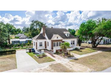 Charming two-story home with a brick and stucco exterior, landscaped yard, and driveway at 1413 Dorothy Ave, Haines City, FL 33844