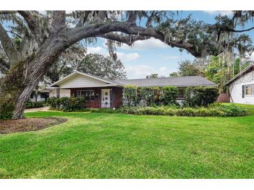 Charming single-story home with lush landscaping and a large, majestic oak tree at 5024 Saint Germain Ave, Belle Isle, FL 32812