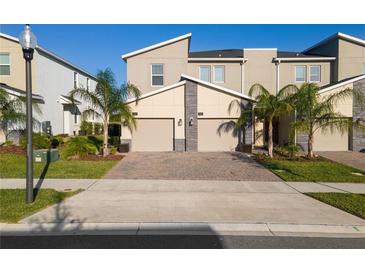 Two-story townhome with attached garage and landscaping at 781 Ocean Course Ave # 601, Davenport, FL 33896