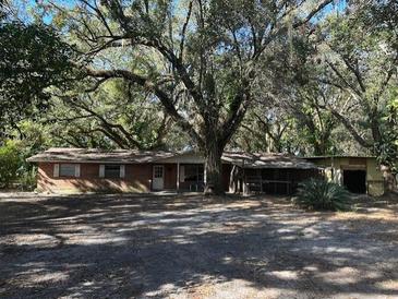 Ranch-style home with mature trees and a large yard at 1918 Mountain Lake Cutoff Rd, Lake Wales, FL 33859