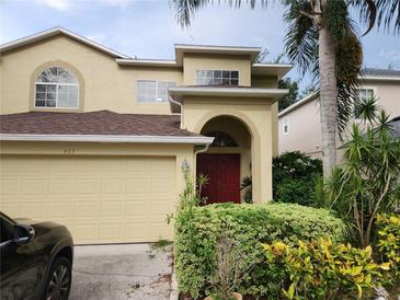 Two-story house with a two-car garage and manicured landscaping at 433 Eastbridge Dr, Oviedo, FL 32765