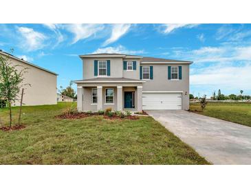 Two-story house with gray siding, dark shutters, and a white garage door at 1245 Limbali St, Mount Dora, FL 32757