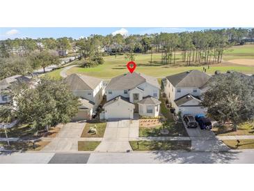 Two-story house with golf course views and a two-car garage at 128 Higher Combe Dr, Davenport, FL 33897