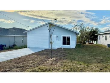 Newly constructed home with modern facade and concrete driveway at 314 N 6Th St, Haines City, FL 33844